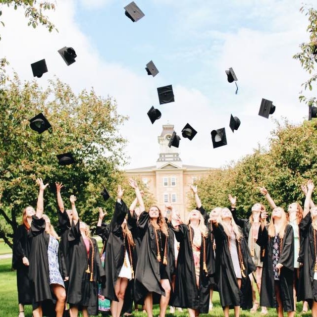 Gusties throwing their caps in the air after graduation.